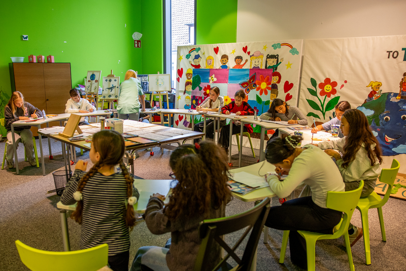 Große Gruppe malende Kinder