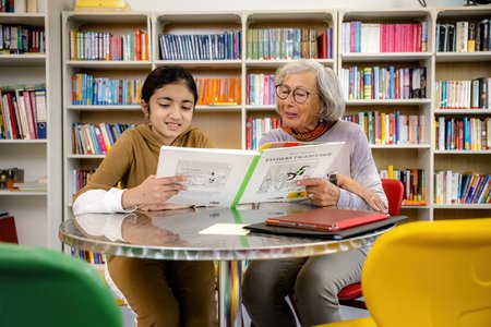 Mentee und Mentorin lesen gemeinsam eine Geschichte